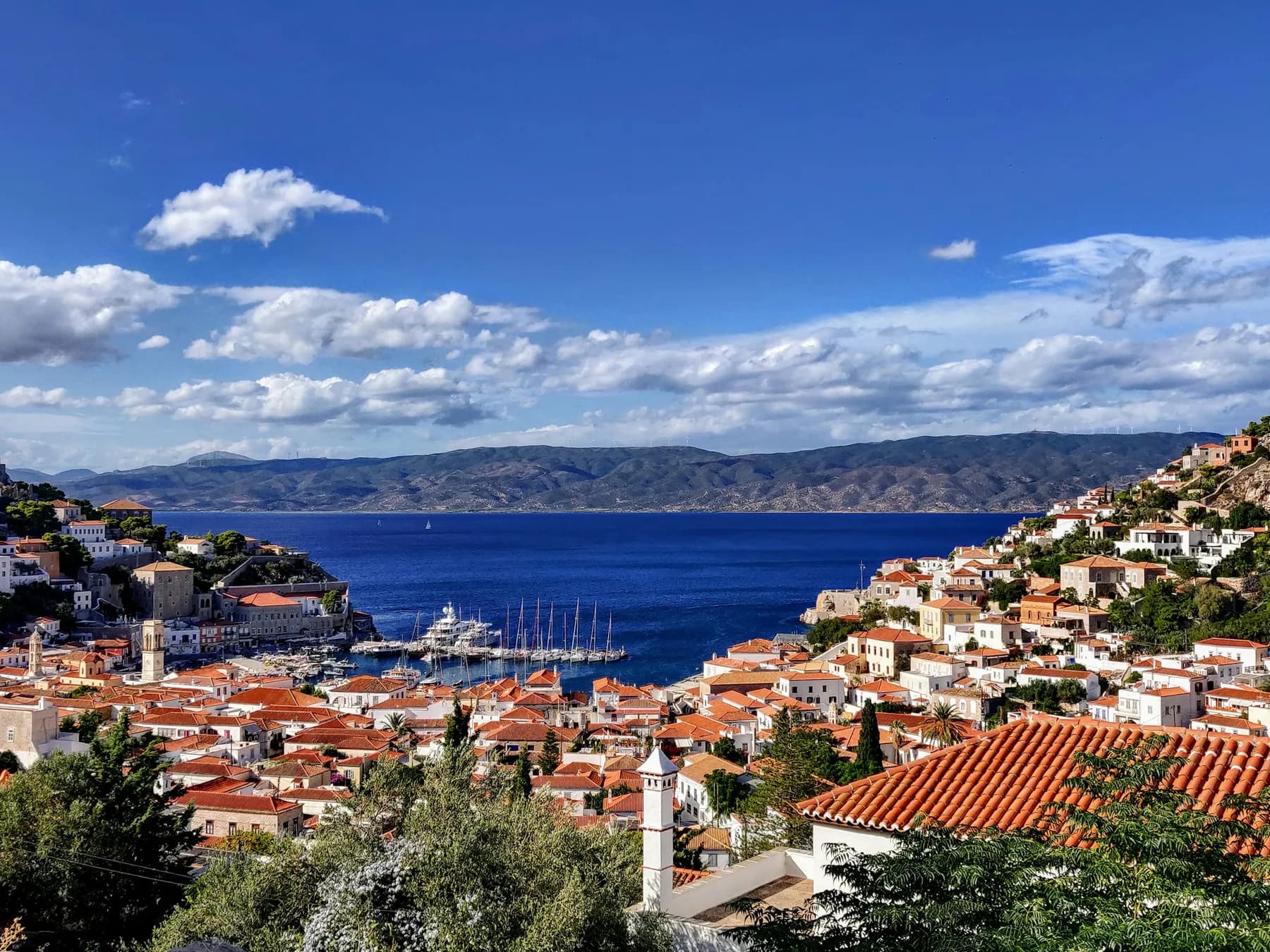 Hydra harbour and its captains' mansions rising up the hillside