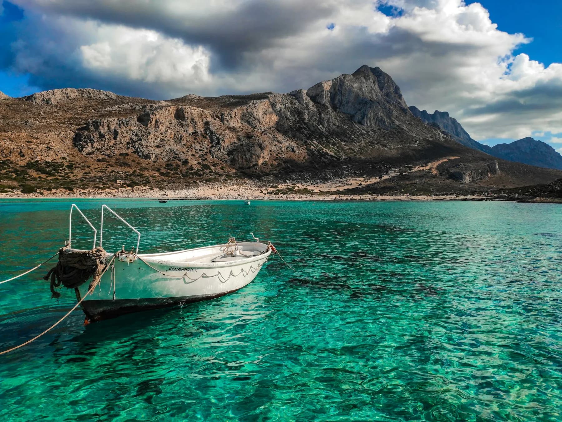 A boat anchored in the turquoise lagoon of Balos, at the north-west tip of Crete